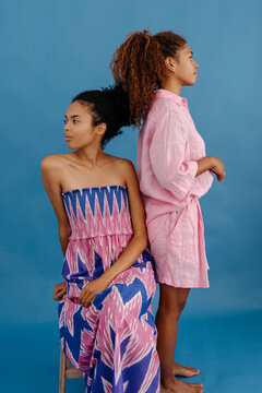 Curly female models looking away in studio