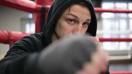 Man, boxer and personal trainer on ring background for practice, coaching or sports training at gym. Male person professional fighter in late evening for self defense, MMA or combat - Powered by Adobe