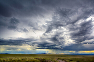 Nature's Drama: 4K Ultra HD Image of Beautiful Natural View of Thundercloud with Rain on the Plains Road	