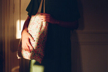 A woman with a flowery bag indoors