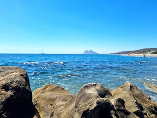 An image of the sea and beach where you can see Gibraltar
