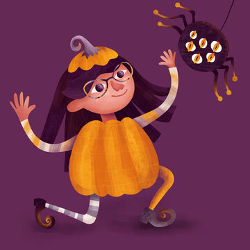 A girl in halloween pumpkin costume playing with spider