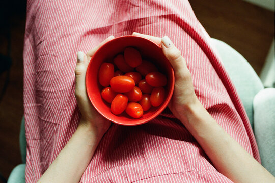 Cherry tomatoes in a red bowl