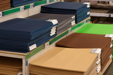 Rubber colored perforated mats on shelves in a store, selective focus.