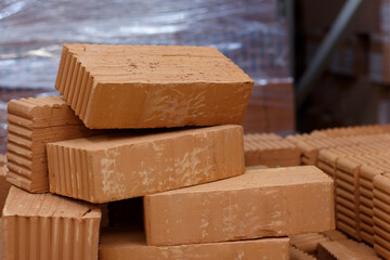 Solid red bricks in a warehouse, selective focus.