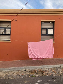 A sheet is hung to dry outside an apartment