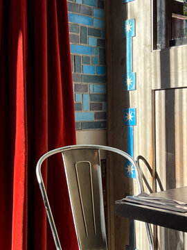 A single chrome chair in a bright cafe