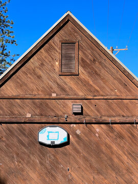 An old barn with a basketball hook on the side