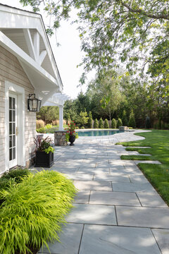 luxury Home outdoor flagstone terrace patio to swimming pool 