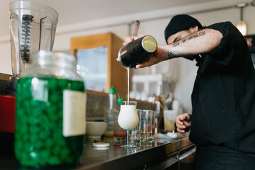 Bartender pouring a cocktail