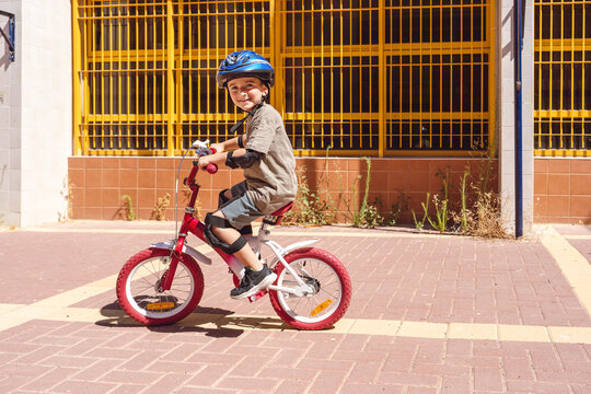 Boy on Bike Whis Helmet, Protective Gear Radiating Joy and Confidence.