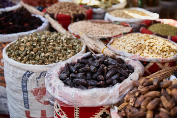 Variety organic okra and dates in sacks on sale on a farmers market. Traditional arabic market