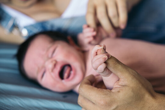 Crying baby on the bed