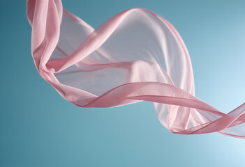 Flying pink fabric wave on blue sky background and illuminated by sunlight