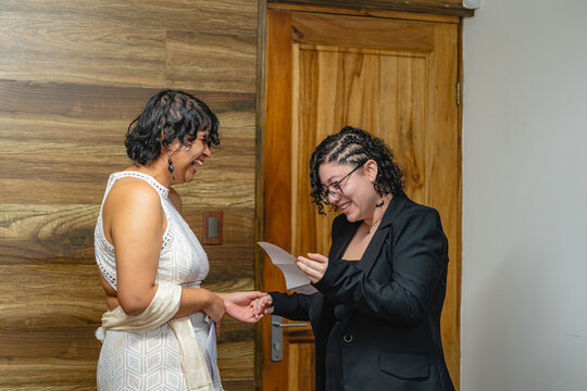 Woman reading vows to her lgbt partner at her wedding