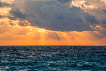 sunbeam from behind the cloud above sea