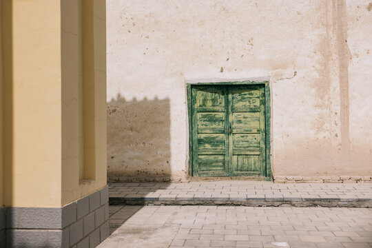 Aged Green Door on a White Wall