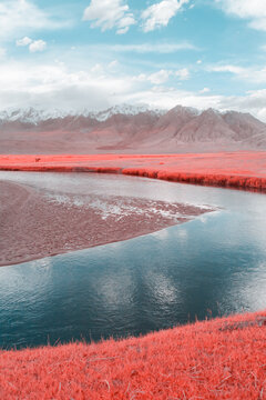 Infrared Photo Of Serene River Flowing Through Mountainous Landscape