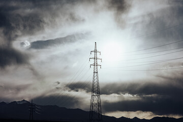 Silhouetted Power Lines Against Cloudy Sky