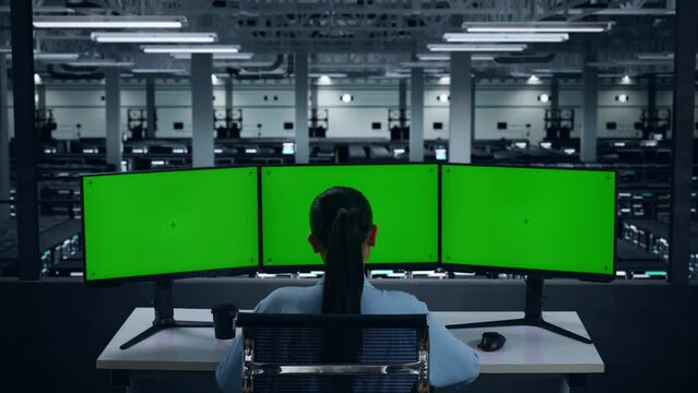Back View Of Asian Woman Working With Mock Up Multiple Computer Monitor In Data Center