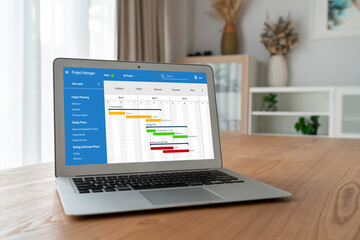 Project planning software for modish business project management on the computer screen showing timeline chart of the team project