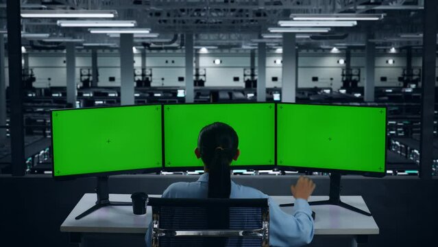 Back View Of Tired Asian Woman Yawning Before Sleeping While Working With Mock Up Multiple Computer Monitor In Data Center