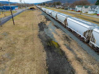 Sayre, PA, USA - 03-03-2024 - Cloudy winter aerial image of a bulk materials railroad car near...