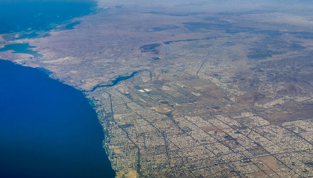 aerial landscape view of Jeddah a port city in Makkah Province, Saudi Arabia with coastline, city and King Abdulaziz International Airport