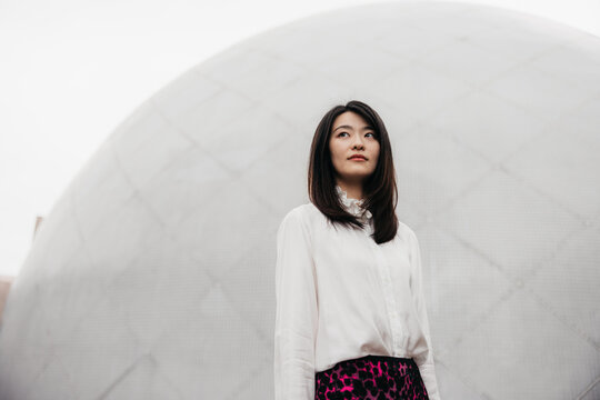 Urban Elegance: Woman Against Geometric Backdrop