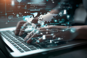 Close-up of a person's hands typing on a laptop keyboard. The scene is overlaid with graphics related to digital technology.