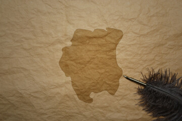 map of suriname on a old paper background with old pen