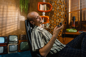 A man with a lighter in his hand in a retro interior