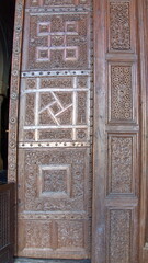 Fototapeta na wymiar Carved wood trim around the door to the prayer hall in the Great Mosque of Kairouan, in Kairouan, Tunisia