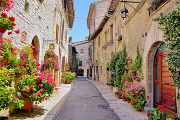 Beautiful flower filled street in the medieval old town of Assisi, Umbria, Italy - 753936962