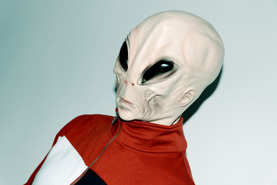 person wearing an alien mask