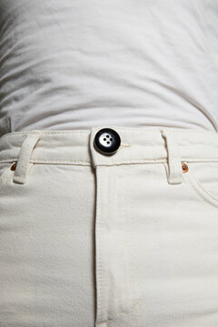 Close-up of person white jeans and white wrinkled top
