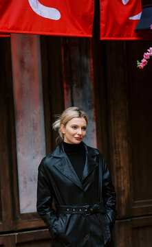 Young blond woman on the rainy street