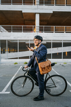 A man in a helmet uses a mobile outdoor