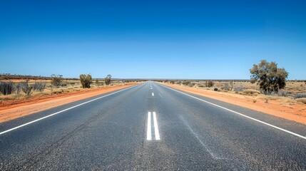 Fototapeta na wymiar Straight road with white lines in middle of outback red centre Australia