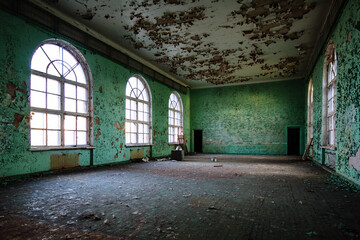 Large hall of abandoned building with peeled paint