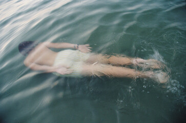 Teen swimming underwater in the sea