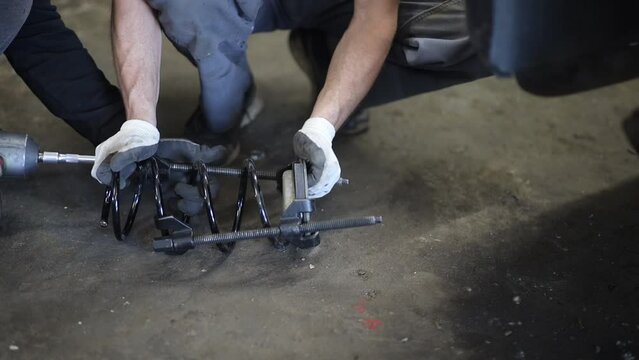 replacing car springs and shock absorbers at a car service center