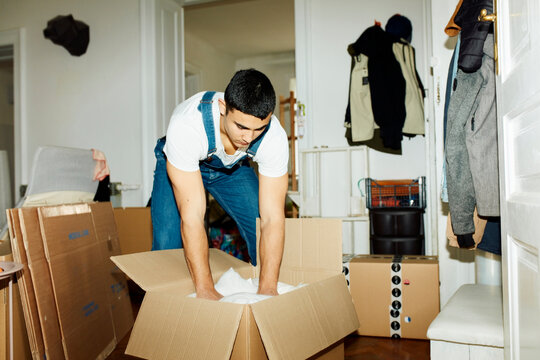 Man packs things into a box