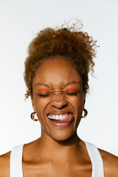 Cheerful woman with red makeup doing a funny face