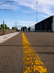 Yellow and white lines along a train station platform