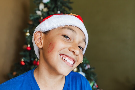 Boy with lipstick on his cheek. 