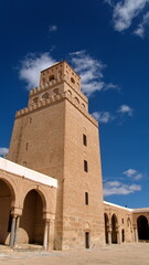 Fototapeta na wymiar Minaret of the Great Mosque of Kairouan, seen from the inner courtyard, in Kairouan, Tunisia