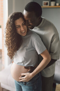 Loving Pregnant Couple Standing at home