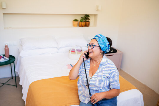 Mature Plus-Size Woman Smiling While Talking on Phone fro