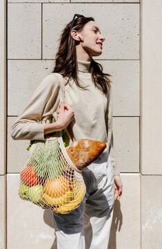 Young female with food in reusable bag